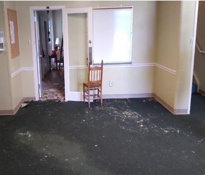 Hall and college dorm apartment with heavy water damage and fallen ceiling.